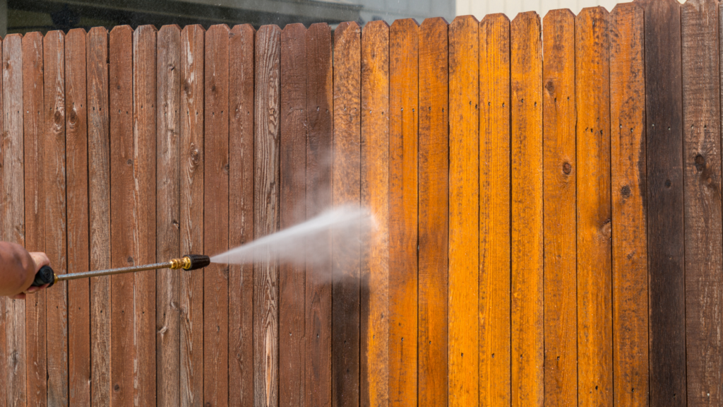 Wood fence pressure washing before and after — soft washing fence cleaning service in Palmetto FL by Eastport Cleaning